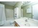 Clean bathroom featuring a tub/shower combo, white tiled walls, and vanity with storage at 1466 Arrow Wind Ter, Charleston, SC 29414