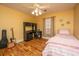 Cozy bedroom with wood floors, a ceiling fan, a window, and a desk area at 1466 Arrow Wind Ter, Charleston, SC 29414