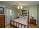 Charming bedroom with a four-poster bed, wood floors, and decorative lighting at 1466 Arrow Wind Ter, Charleston, SC 29414