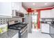 Well-lit kitchen boasts stainless steel appliances, granite counters, white cabinets, and tile backsplash at 1466 Arrow Wind Ter, Charleston, SC 29414