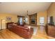 Open-concept living room featuring a stone fireplace, hardwood floors, and ample natural light at 1466 Arrow Wind Ter, Charleston, SC 29414