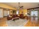 Spacious living room featuring hardwood floors, a leather sectional, and an open layout at 1466 Arrow Wind Ter, Charleston, SC 29414