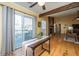 Open-concept living area featuring a stone fireplace, wood beams, and sliding glass doors to the backyard deck at 1466 Arrow Wind Ter, Charleston, SC 29414