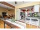 View of the living room and kitchen with granite countertops, stainless steel appliances, and breakfast bar seating at 1466 Arrow Wind Ter, Charleston, SC 29414