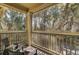Screened in balcony featuring seating and view of surrounding tree canopy at 1600 Long Grove Dr # 1727, Mount Pleasant, SC 29464