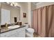 A simple bathroom has granite countertops, white cabinets, and tile flooring at 1600 Long Grove Dr # 1727, Mount Pleasant, SC 29464
