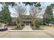 Well-manicured exterior of the community clubhouse featuring a golf cart, palm trees, and a charming brick facade at 1600 Long Grove Dr # 1727, Mount Pleasant, SC 29464