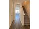 Inviting hallway shows staircase, attractive floors, and views of the adjacent living space at 2204 Scarlett Maple St, Summerville, SC 29486