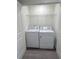 Convenient laundry room featuring washer, dryer, and wire shelving for storage at 2204 Scarlett Maple St, Summerville, SC 29486