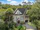 Expansive aerial view of home surrounded by lush greenery and mature trees at 176 Marsh Hawk Ln, Kiawah Island, SC 29455