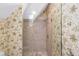 Bathroom featuring a glass shower door and floral-patterned wallpaper at 176 Marsh Hawk Ln, Kiawah Island, SC 29455