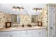 Bathroom with dual sinks, floral wallpaper, and ample counter space at 176 Marsh Hawk Ln, Kiawah Island, SC 29455