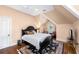 Charming bedroom with a large dark-stained bed frame, hardwood floors, and a cozy sitting area at 176 Marsh Hawk Ln, Kiawah Island, SC 29455