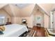 Spacious bedroom with hardwood floors, a comfortable bed, and ample natural light from two windows at 176 Marsh Hawk Ln, Kiawah Island, SC 29455