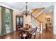 Sophisticated dining area with hardwood floors, a wooden table, and a view of the staircase and outdoor scenery at 176 Marsh Hawk Ln, Kiawah Island, SC 29455