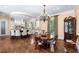 Elegant dining area with a wooden table, chandelier, and seamless flow into the spacious, updated kitchen at 176 Marsh Hawk Ln, Kiawah Island, SC 29455