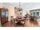 Elegant dining area showcasing hardwood floors, a wooden table, and seamless access to the living room and staircase at 176 Marsh Hawk Ln, Kiawah Island, SC 29455
