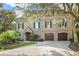 Charming home with a two-car garage, brick accents, and mature landscaping at 176 Marsh Hawk Ln, Kiawah Island, SC 29455