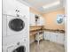 Well-equipped laundry room with white cabinets, modern washer and dryer, and granite countertops at 176 Marsh Hawk Ln, Kiawah Island, SC 29455