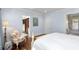 Bright main bedroom with a large window, floral chair and hardwood floors, leading to a closet and bathroom at 176 Marsh Hawk Ln, Kiawah Island, SC 29455