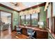 Home office with hardwood floors, custom window coverings, and built in desk at 176 Marsh Hawk Ln, Kiawah Island, SC 29455