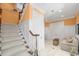 Carpeted staircase with white banister and wood railing leads to the upper level of the home at 176 Marsh Hawk Ln, Kiawah Island, SC 29455