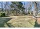 Large backyard featuring a mature tree, grassy area, and wood fence at 1992 Pierce St, Charleston, SC 29492
