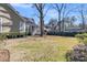 Backyard with a large lawn and mature trees at 1992 Pierce St, Charleston, SC 29492