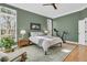 Bright bedroom featuring green walls, hardwood floors, large windows, and a comfortable sitting area at 1992 Pierce St, Charleston, SC 29492