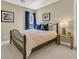 Bedroom featuring a bed, side table, and a window with blue curtains at 1992 Pierce St, Charleston, SC 29492