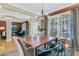 Bright dining room with modern chandelier, wooden table, and large window at 1992 Pierce St, Charleston, SC 29492