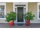 The front door framed by planters, adding a touch of natural elegance at 1992 Pierce St, Charleston, SC 29492