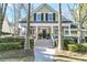 Charming home featuring a welcoming front porch, classic shutters, and manicured landscaping at 1992 Pierce St, Charleston, SC 29492