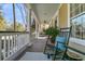 Inviting porch with rocking chairs, decorative pillows, and a ceiling fan for relaxation at 1992 Pierce St, Charleston, SC 29492