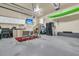 Finished garage with epoxy floors, a TV, and storage cabinets at 1992 Pierce St, Charleston, SC 29492