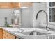 Close-up of a modern kitchen sink with white countertop, wooden cabinets and stainless steel tap at 1992 Pierce St, Charleston, SC 29492