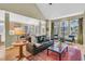 Sunlit living room with hardwood floors, comfortable seating, and a view into the kitchen at 1992 Pierce St, Charleston, SC 29492