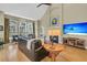 Bright living room with a fireplace, hardwood floors, and large windows offering plenty of natural light at 1992 Pierce St, Charleston, SC 29492