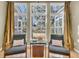 Inviting sitting area featuring armchairs, throw pillows, and a backyard view from the large windows at 1992 Pierce St, Charleston, SC 29492