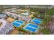 Aerial view of community tennis courts surrounded by lush trees and conveniently located near a swimming pool at 2128 Baldwin Park Dr, Mount Pleasant, SC 29466