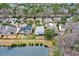 An aerial view of a community home near a pond with backyard, trees, and fence at 2128 Baldwin Park Dr, Mount Pleasant, SC 29466