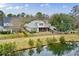 Aerial view of a home with a large backyard and pond, showcasing its peaceful setting at 2128 Baldwin Park Dr, Mount Pleasant, SC 29466