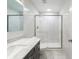 Modern bathroom with walk-in shower, white marble tile, and dark vanity with marble countertop at 2128 Baldwin Park Dr, Mount Pleasant, SC 29466