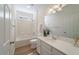 Bathroom featuring white cabinets, a large mirror, and a shower-tub combo at 2128 Baldwin Park Dr, Mount Pleasant, SC 29466