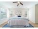 Bright bedroom featuring a ceiling fan, plush bed, and sun-filled windows at 2128 Baldwin Park Dr, Mount Pleasant, SC 29466