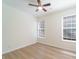 A bright, naturally lit bedroom features wood-look flooring, ceiling fan and double window at 2128 Baldwin Park Dr, Mount Pleasant, SC 29466