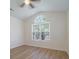 Bright bedroom with wood floors and a unique arched window filling the room with natural light at 2128 Baldwin Park Dr, Mount Pleasant, SC 29466