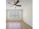Bright bedroom with wood floors, ceiling fan, and large window with natural light at 2128 Baldwin Park Dr, Mount Pleasant, SC 29466