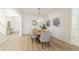 Bright dining room featuring wood floors, wainscoting, stylish lighting and gray dining chairs at 2128 Baldwin Park Dr, Mount Pleasant, SC 29466