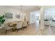 Bright dining room featuring modern lighting, wood floors and beautiful artwork at 2128 Baldwin Park Dr, Mount Pleasant, SC 29466